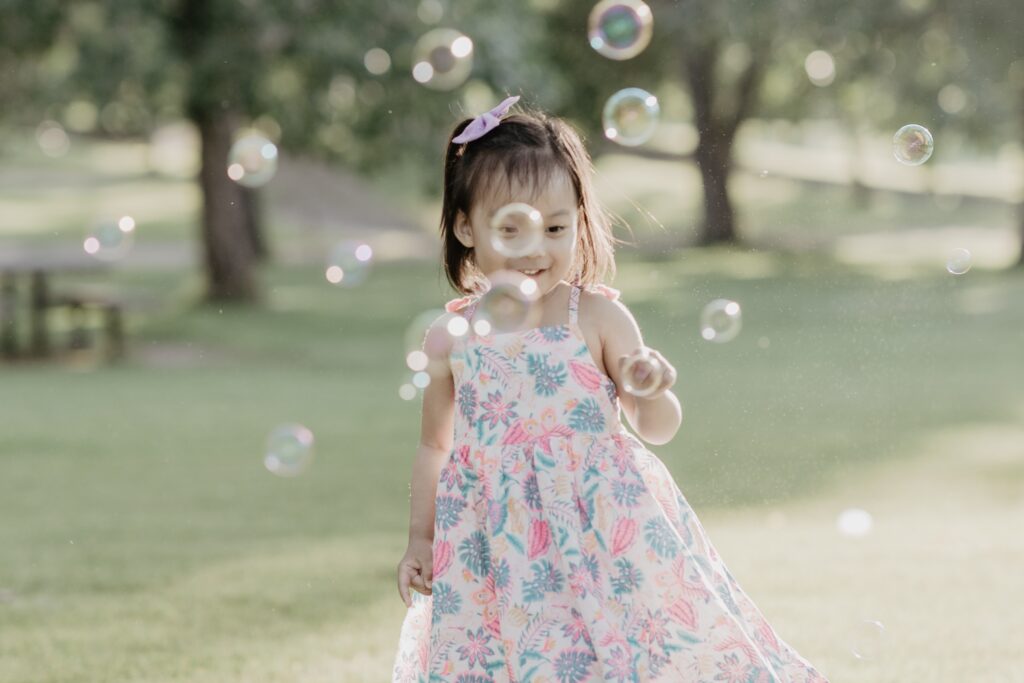 Daughter playing with bubbles during family photo session
