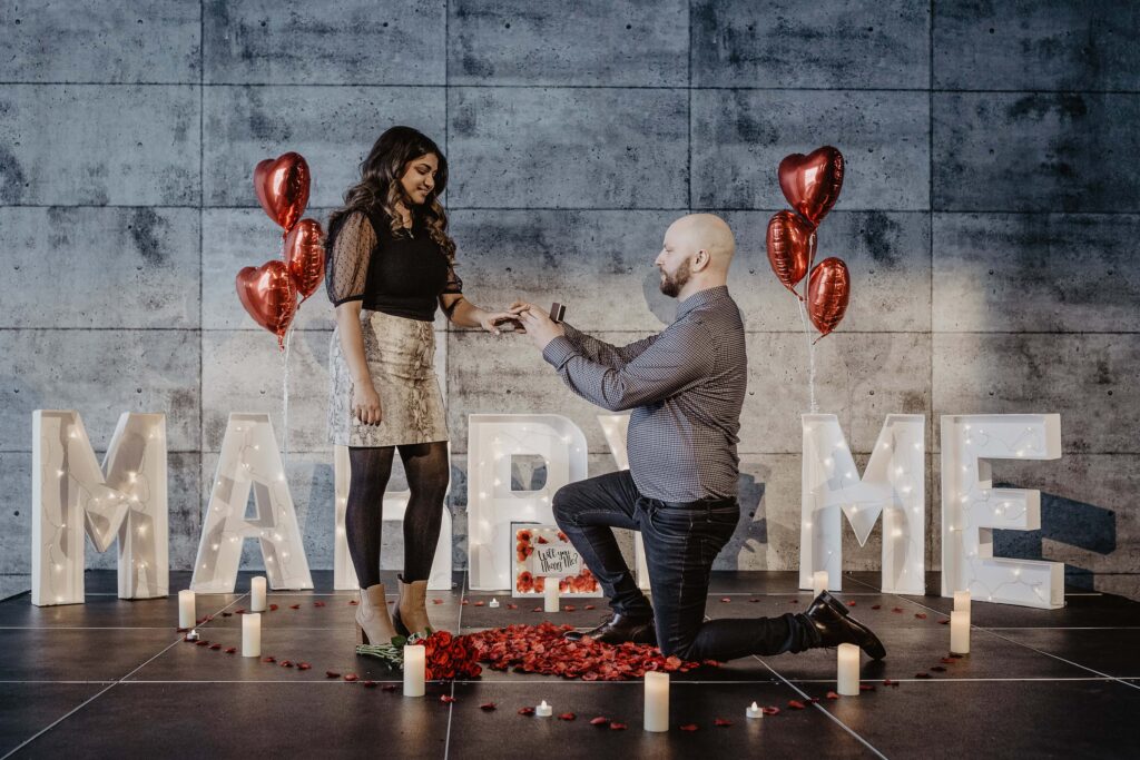 Surprise Proposal in Edmonton photo in front of marry me sign